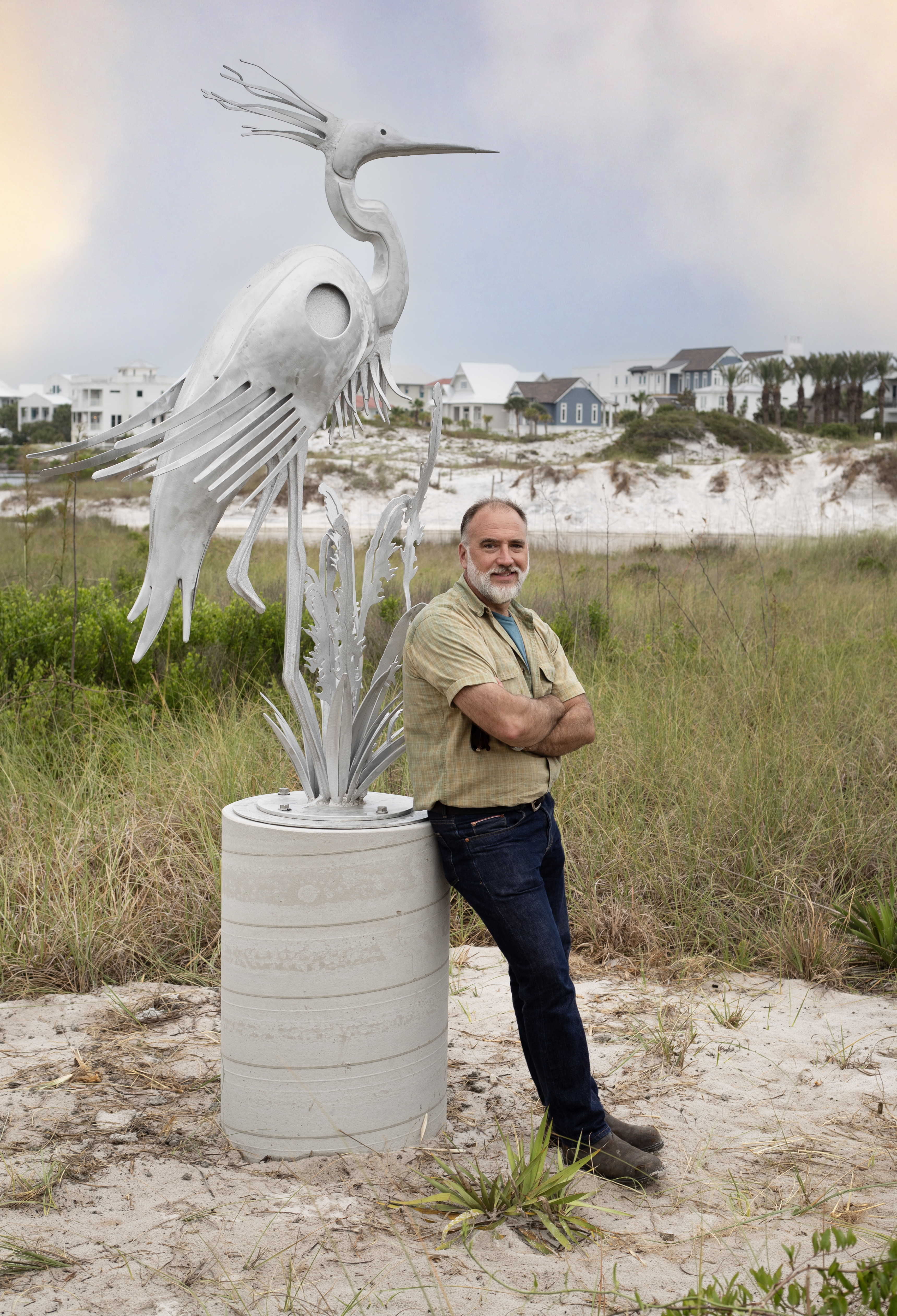 Tallahassee-based artist Mark Dickson stands with sculpture at memorial of Lady of the Lake.